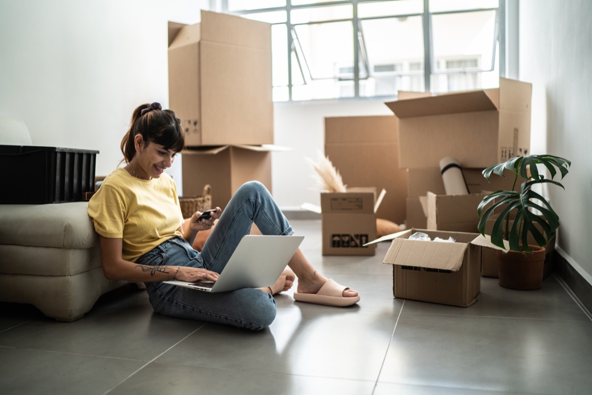 Young woman doing an online shopping for new home