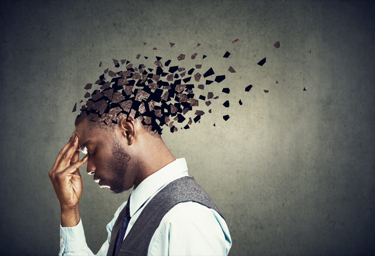 Memory loss due to dementia or brain damage. Side profile of a sad man losing parts of head as symbol of decreased mind function.