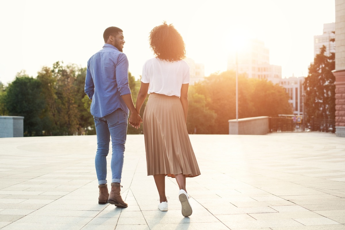 Black couple holding hands and exploring the city together