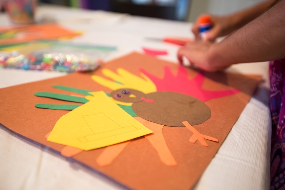 child assembling thanksgiving arts and crafts while playing thanksgiving games