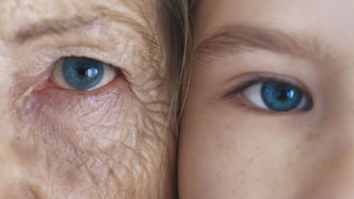 Girl and grandmother, cheek to cheek, close-up, partial view