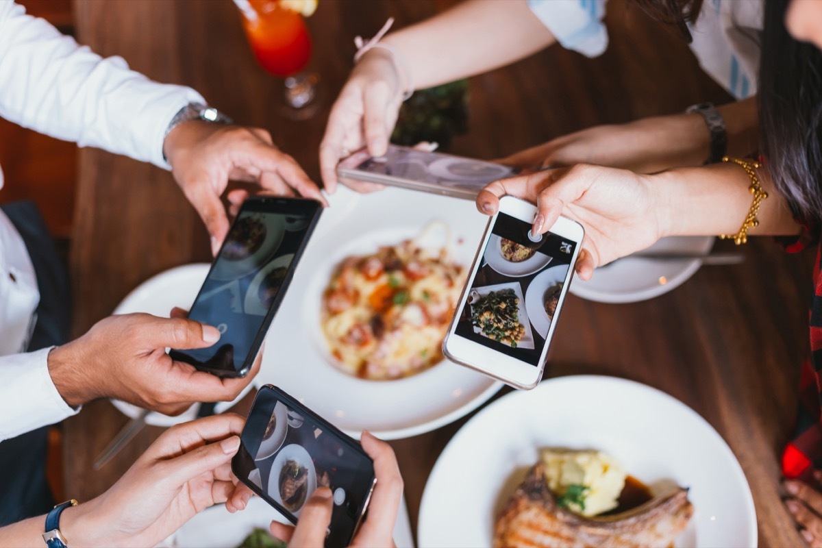 Foodies taking pictures of meal