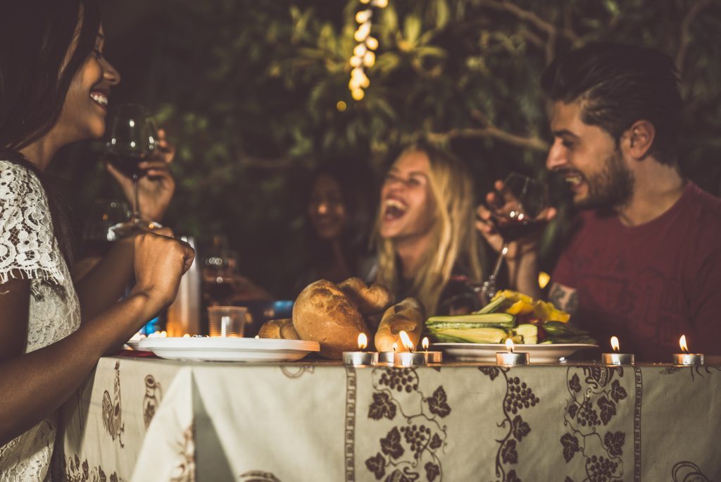 friends at dinner conversationalist laughing