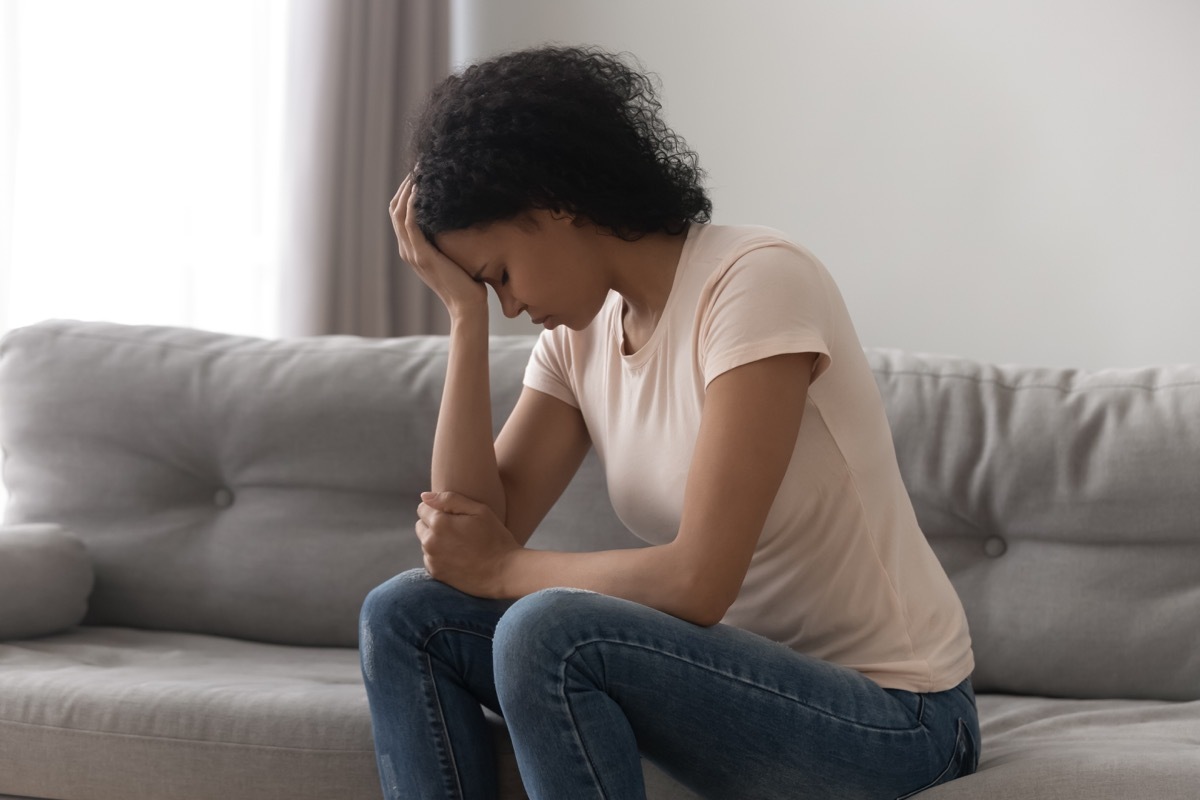 upset woman sitting on couch