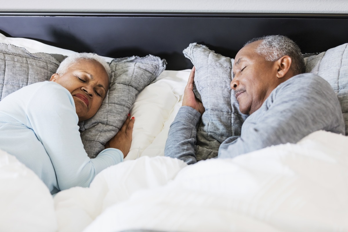 couple sleeping in bed. It is morning, time to get up soon.