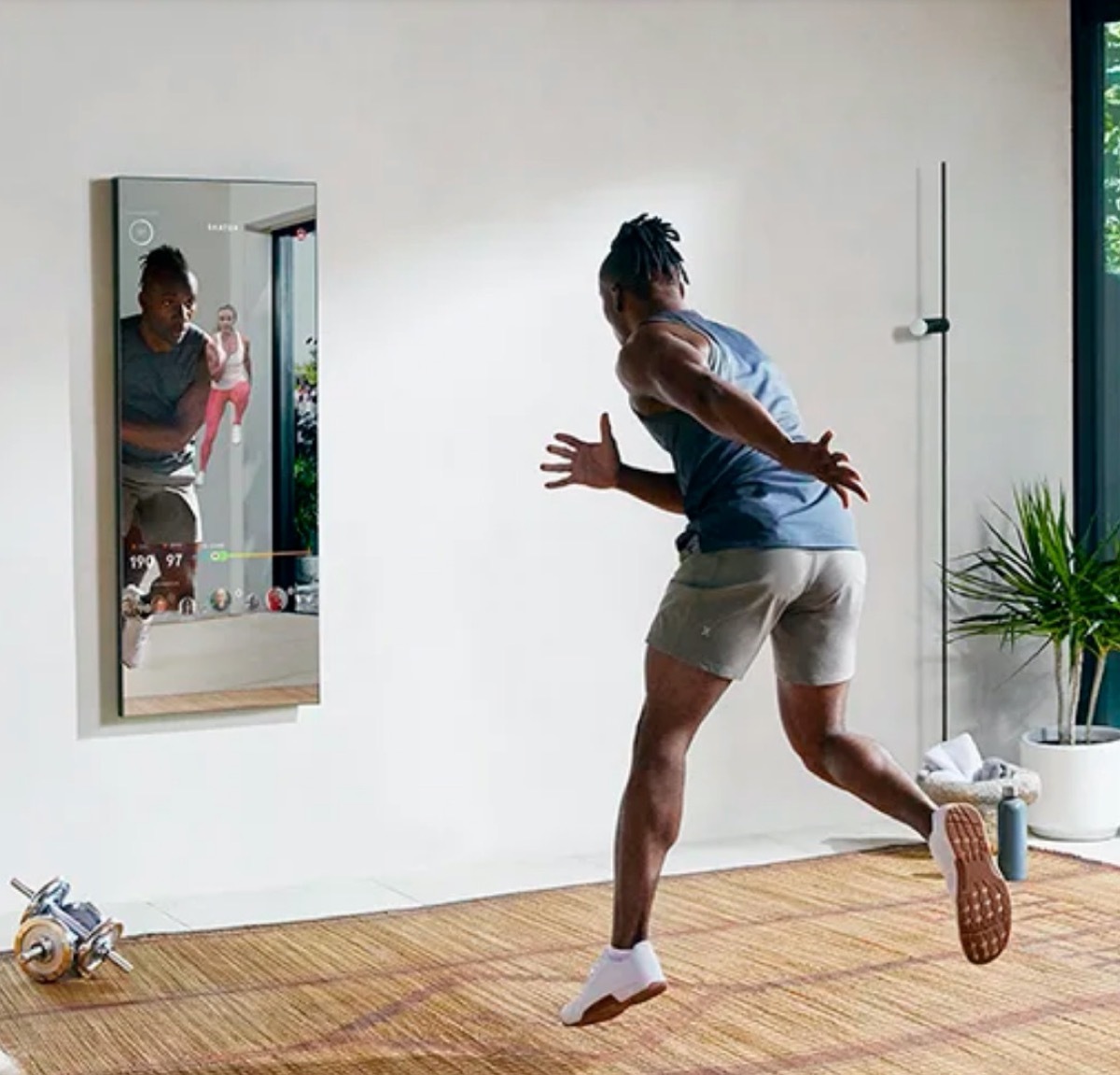 man working out in front of mirror exercise device