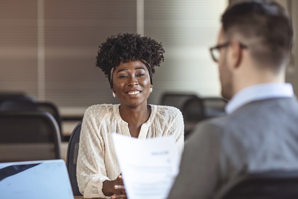 female employee in suit is smiling during the job interview. 