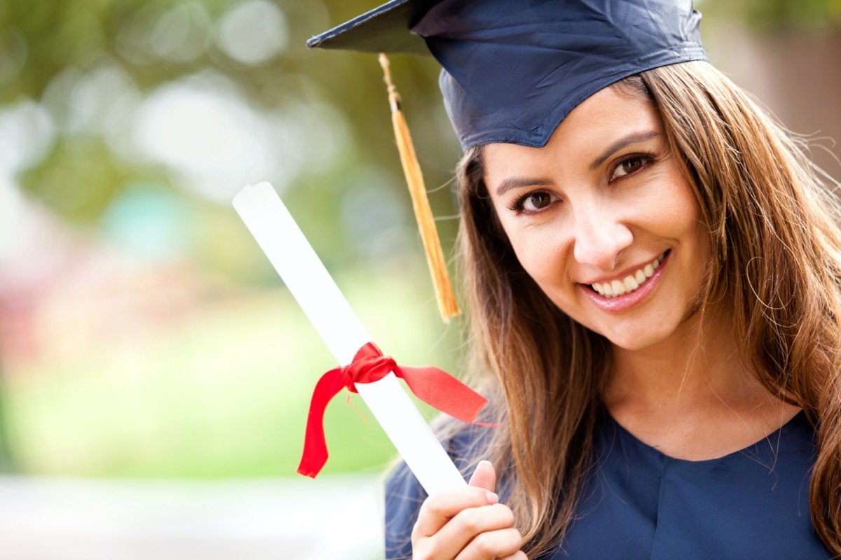 Happy woman portrait on her graduation day smiling