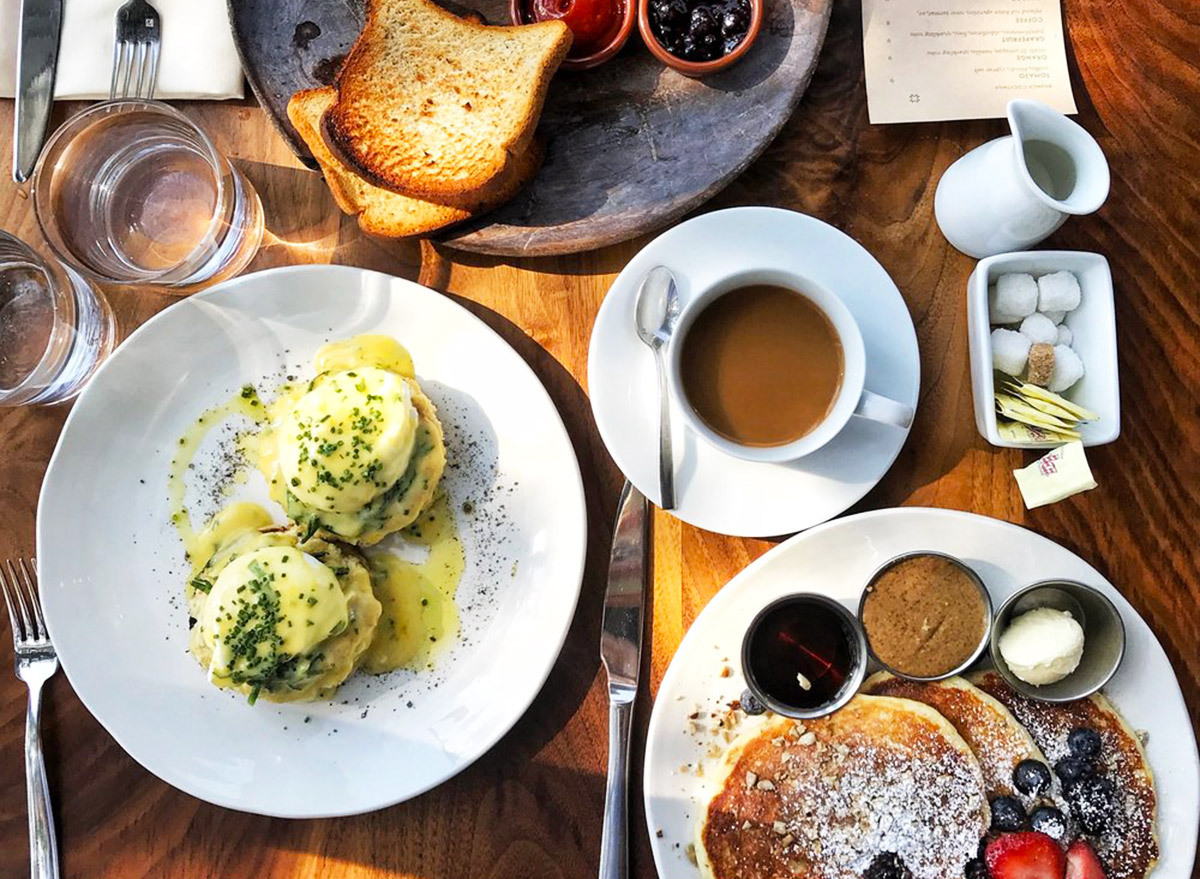 a breakfast spread from above with pancakes, eggs benedict, coffee, and toast from martina