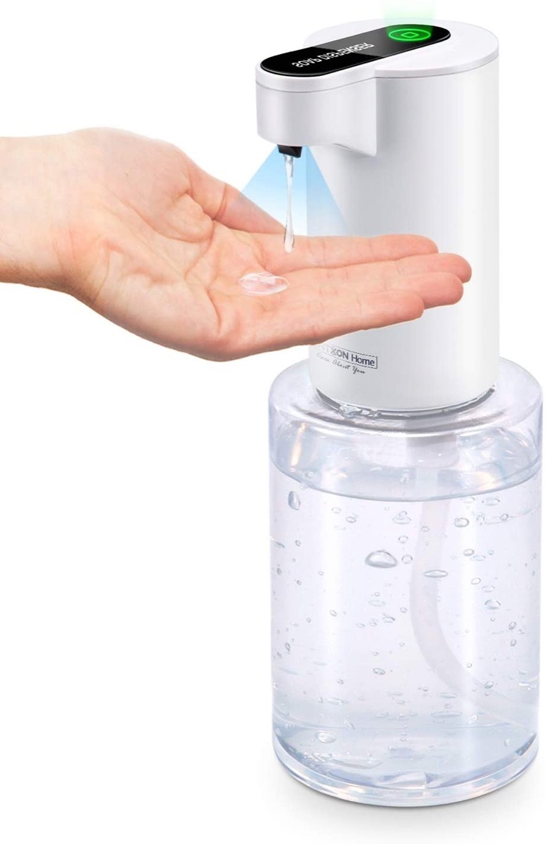 white hand under sanitizer dispenser