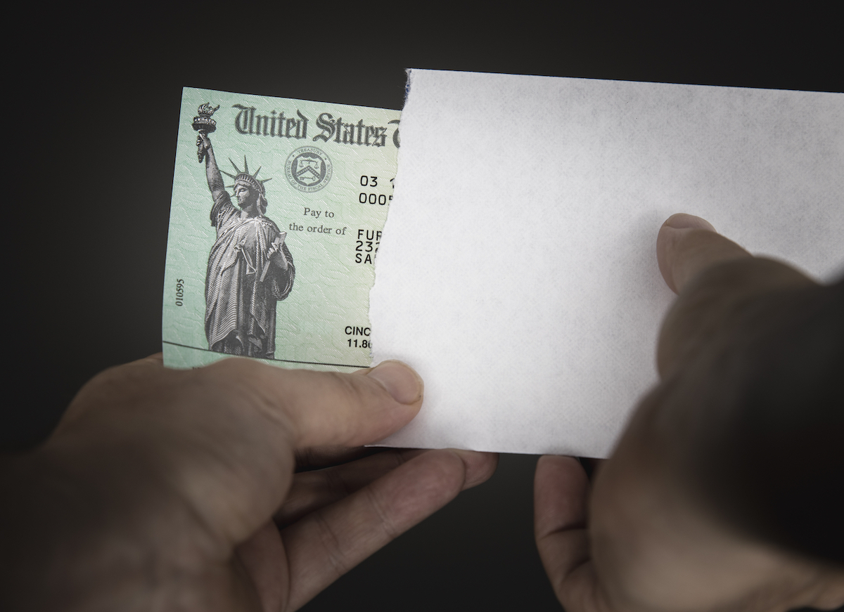 United States Treasury check with envelope arriving in mail.