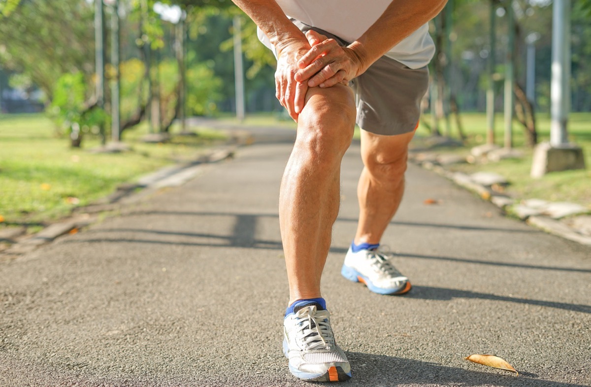 older man stretching before run