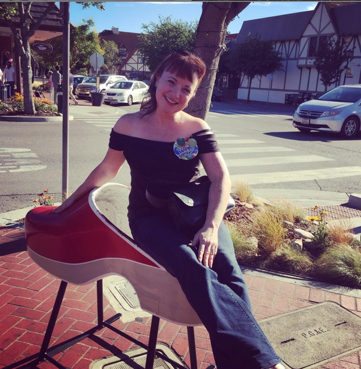 Aileen Quinn Annie actress sitting outside