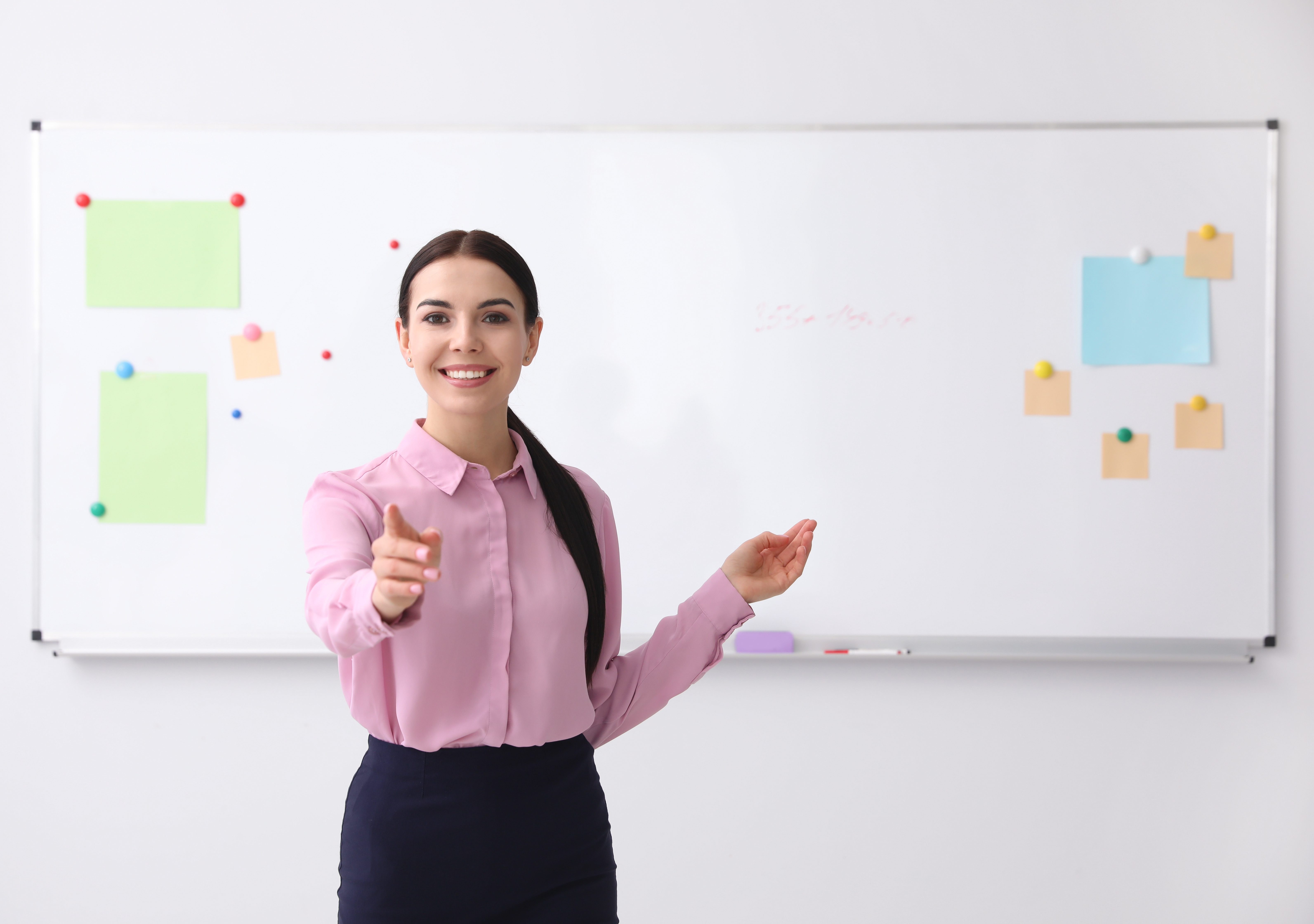 young teacher in front of whiteboard