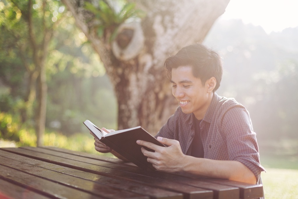 Man Smiling and Reading Poems