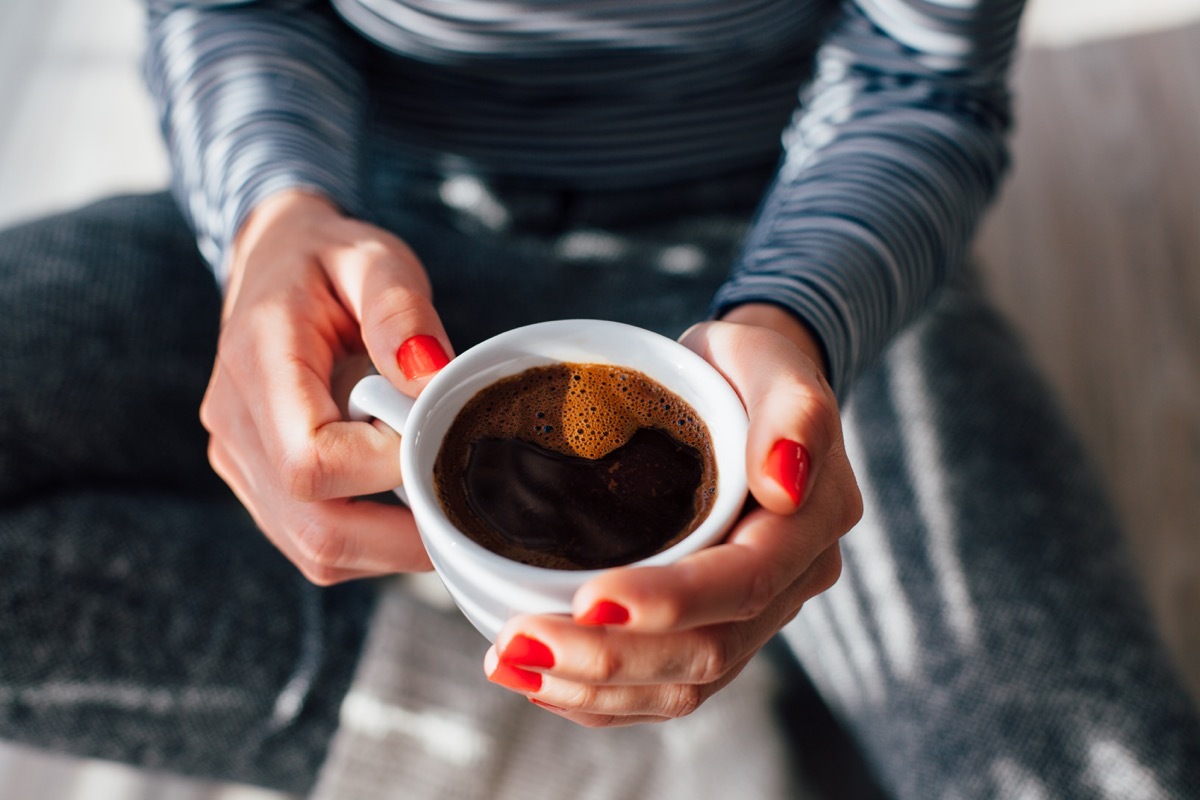 Woman holding cup of coffee