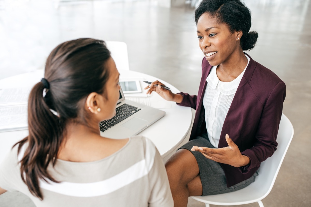 female boss and female employee discussing work together