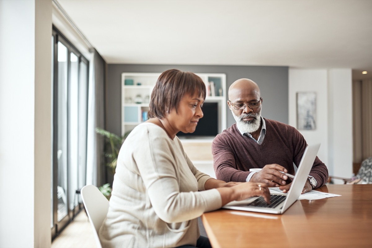 mature couple looking at a computer together in their home