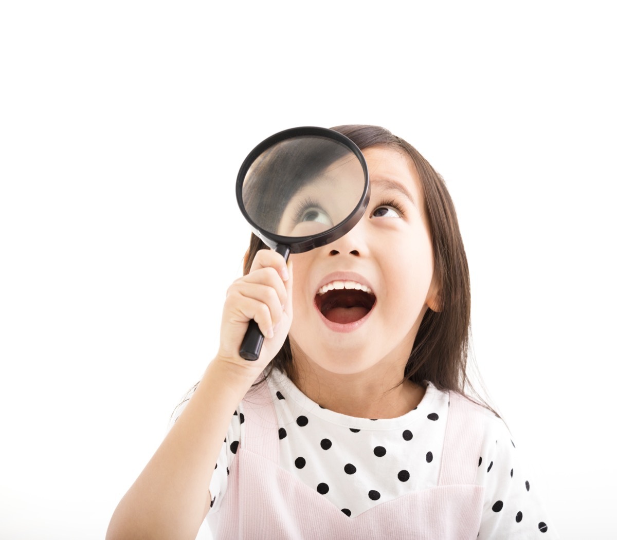 young girl using magnifying glass