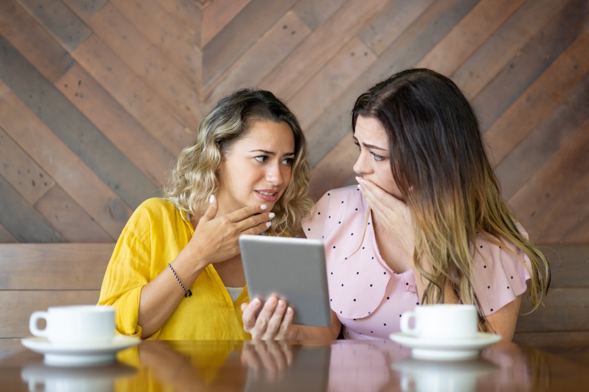 two girls sharing a cringeworthy video with each other