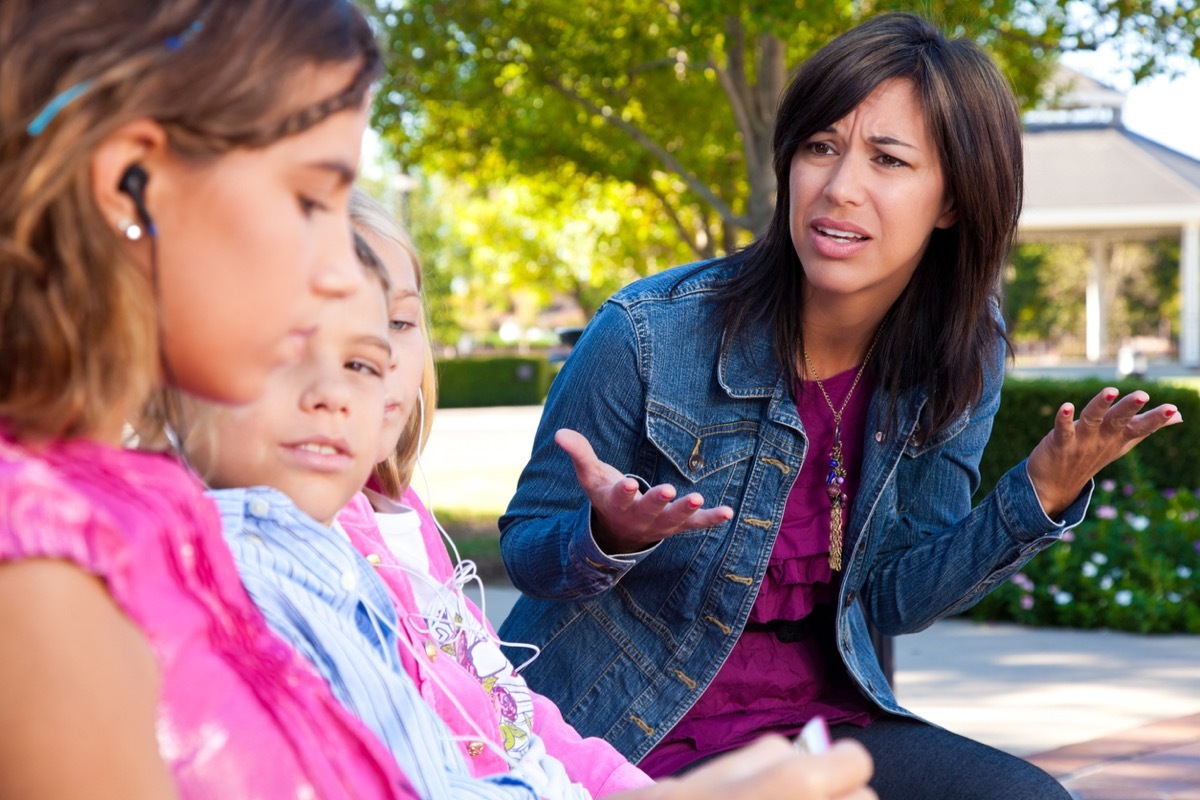 Distraught mother with her kids listening to music