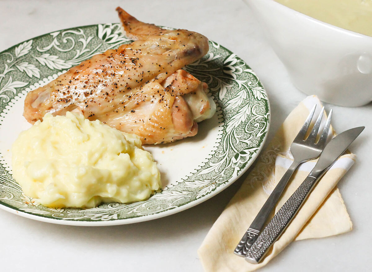 Finished baked turkey wings with mashed potatoes on a plate