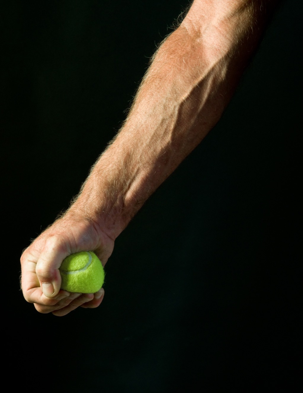 Man squeezing tennis ball for low blood pressure.