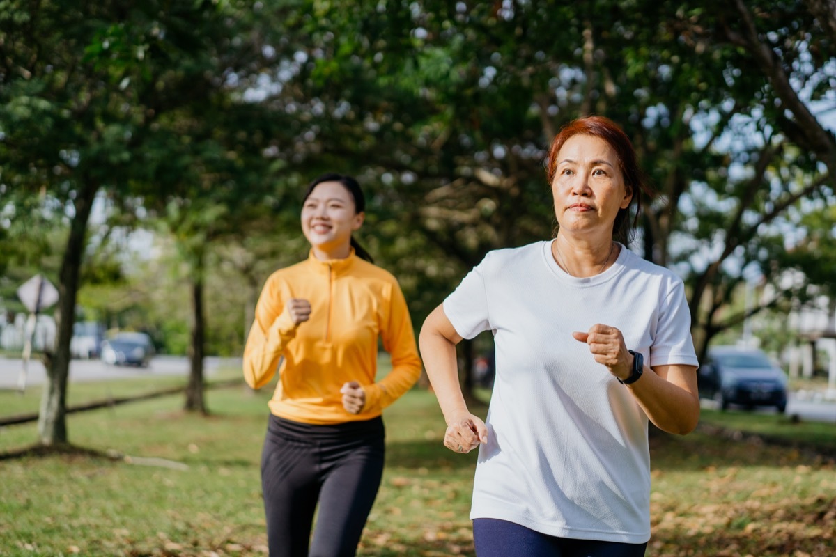 mother and daughter running in the evening at outdoor park