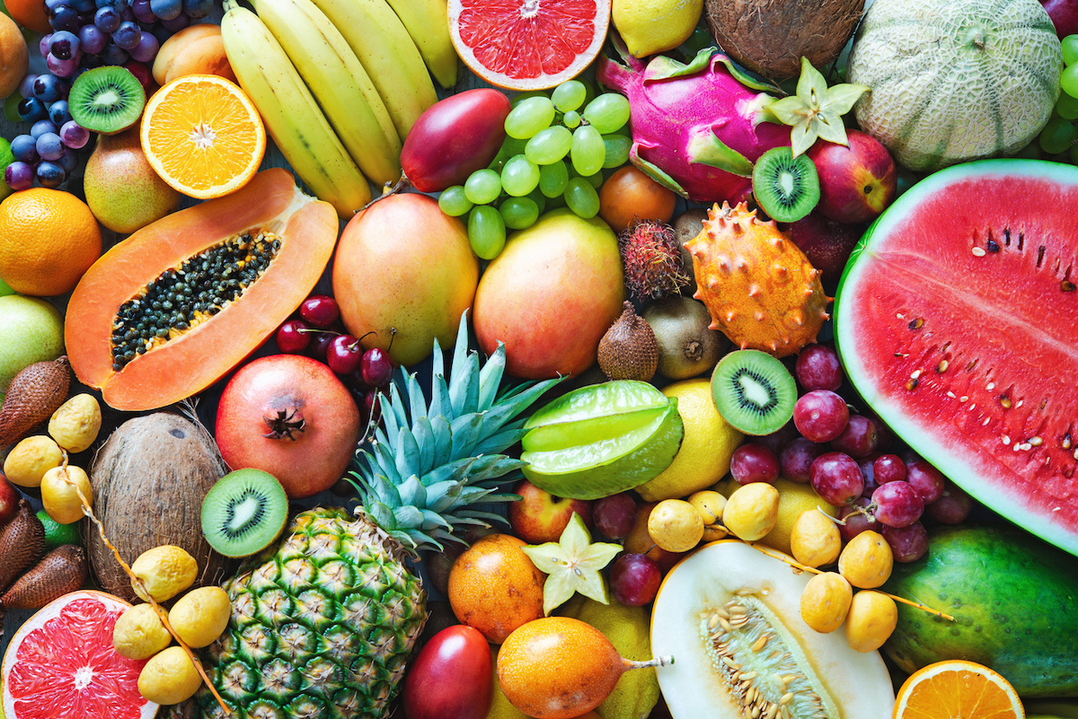 Assortment of colorful ripe tropical fruits, including watermelon