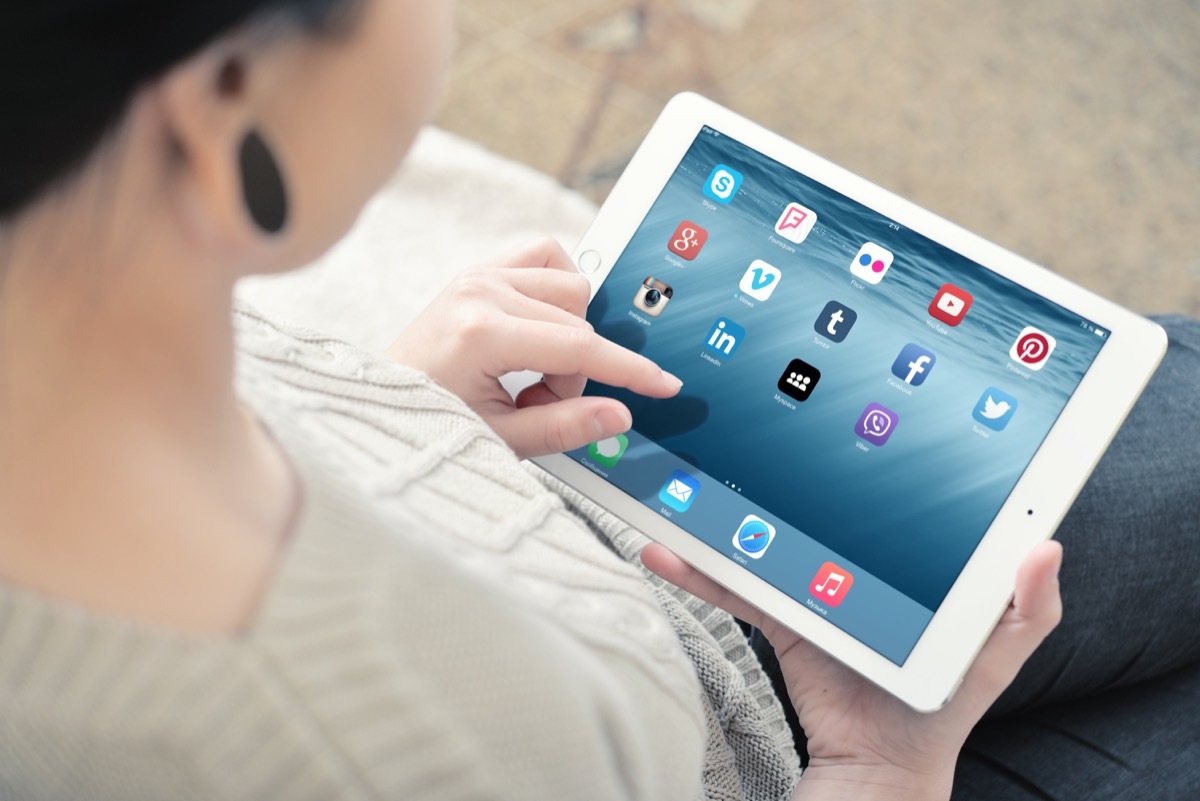 Woman using white Apple iPad Air