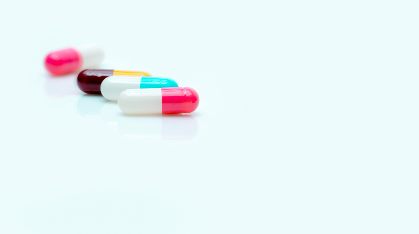 Capsule pills on a white background.