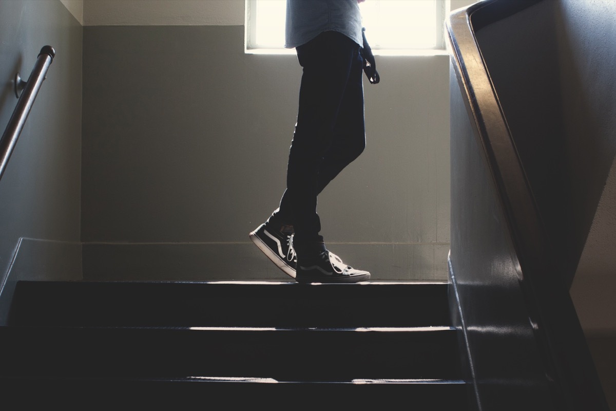 Student walking up a school stairwell classroom surfaces germs