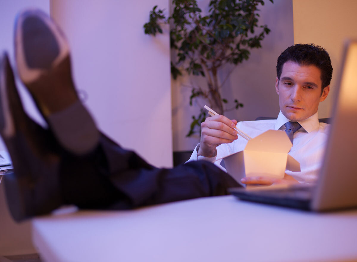 man eating late night at office