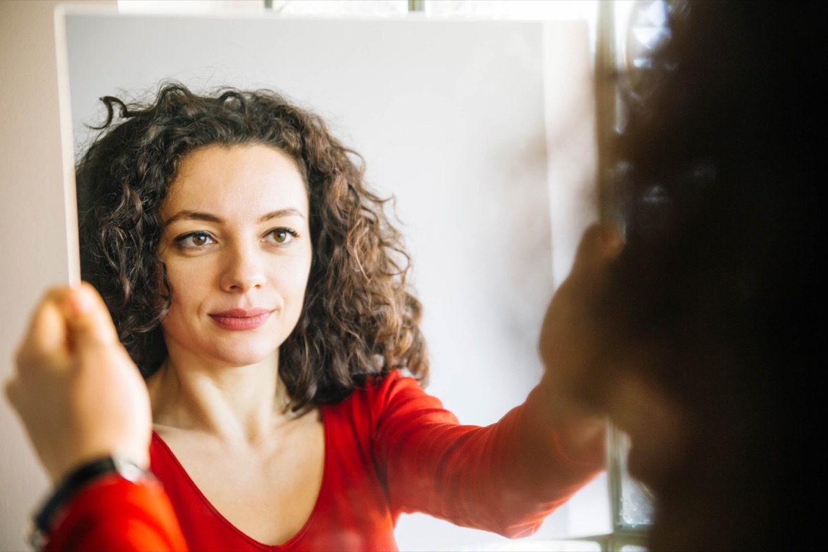 woman looking in the mirror