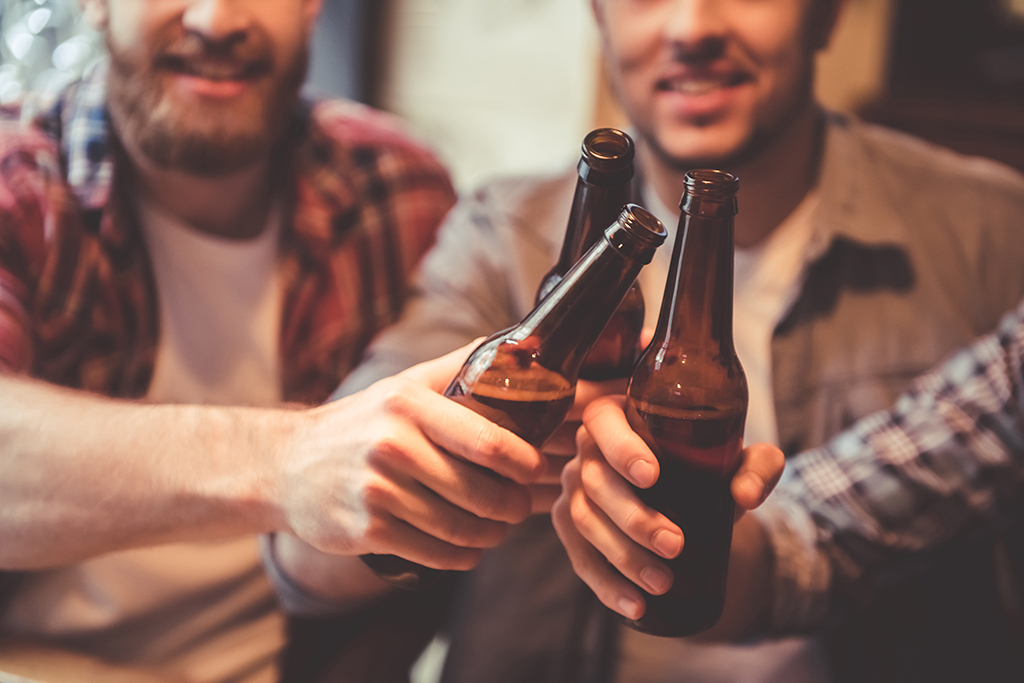 men doing a toast with beer bottles, relationship white lies