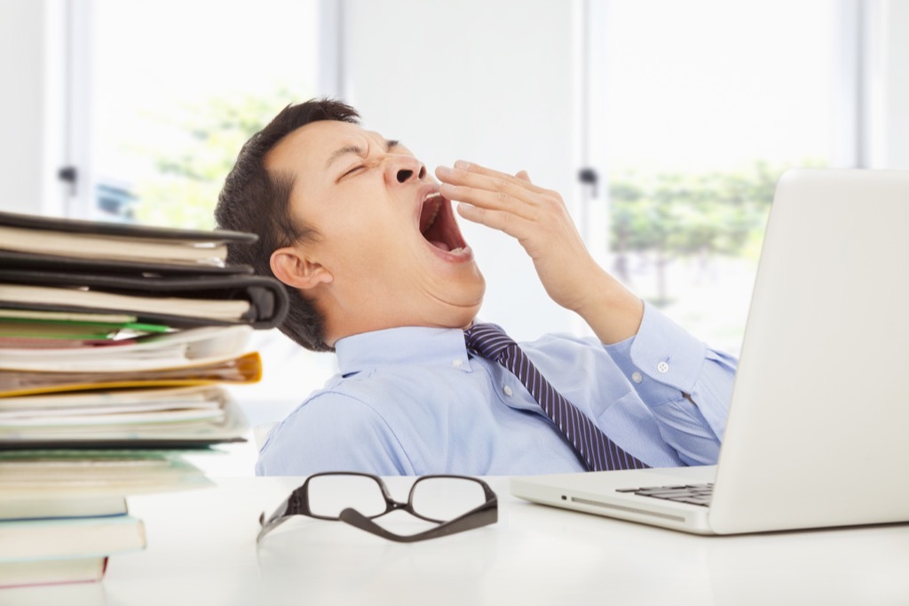 Man yawning at work advice you should ignore over 40