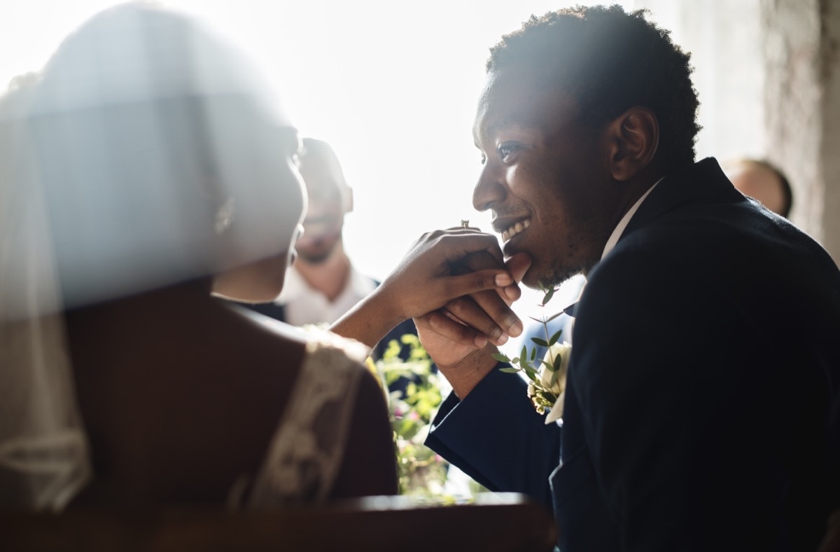 Couple Kissing Hands at wedding