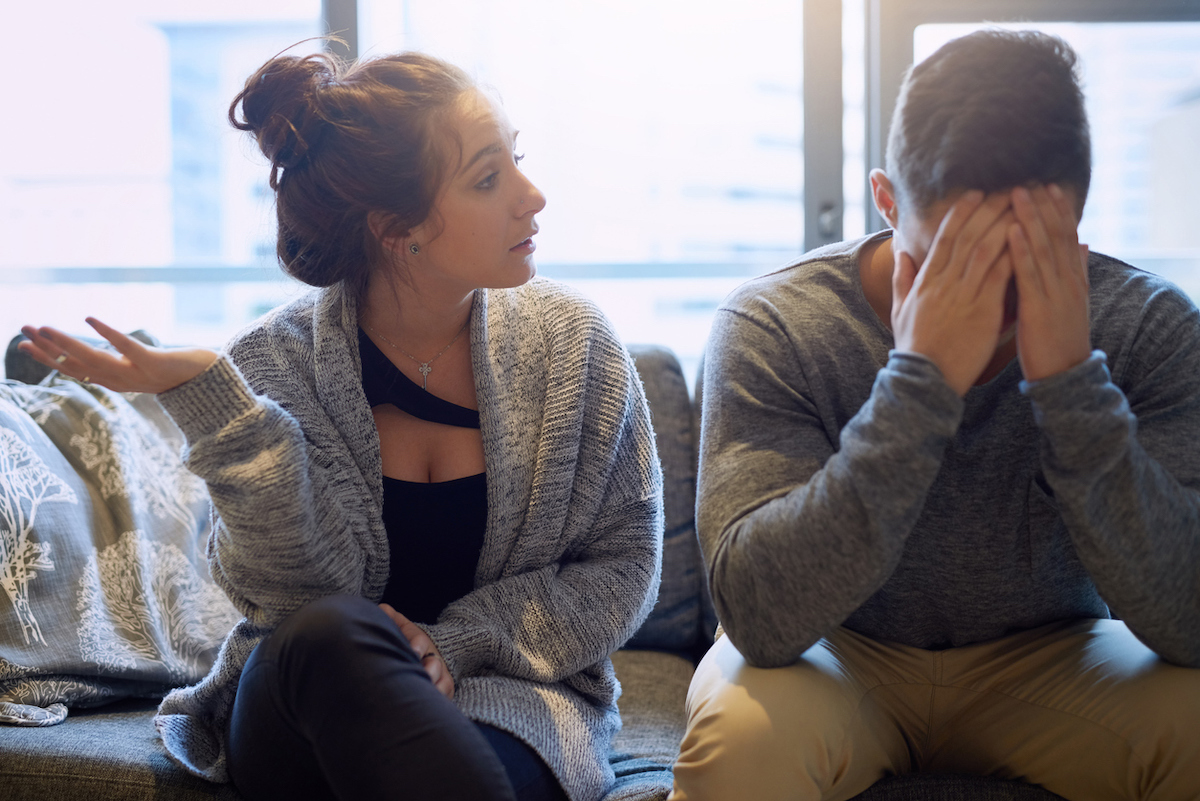 Shot of a young woman scolding her boyfriend in their home