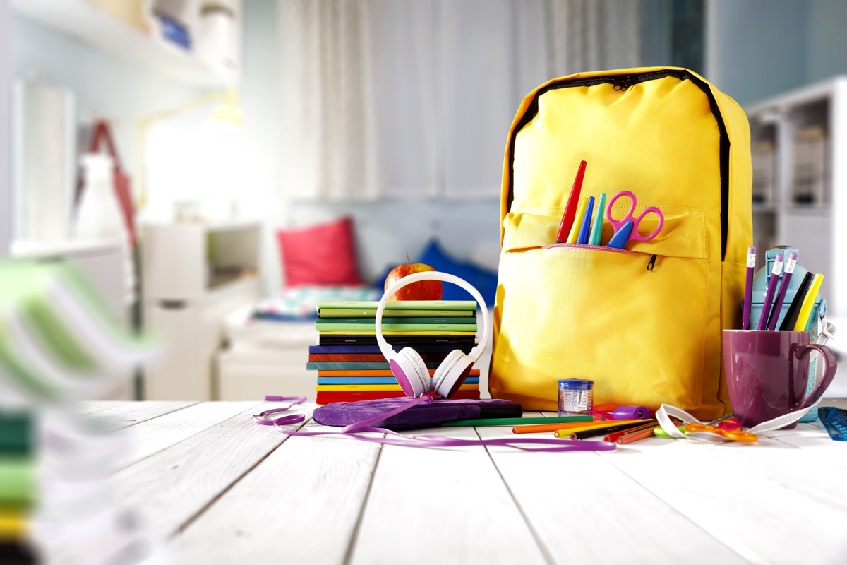 Table of school supplies and a backpack