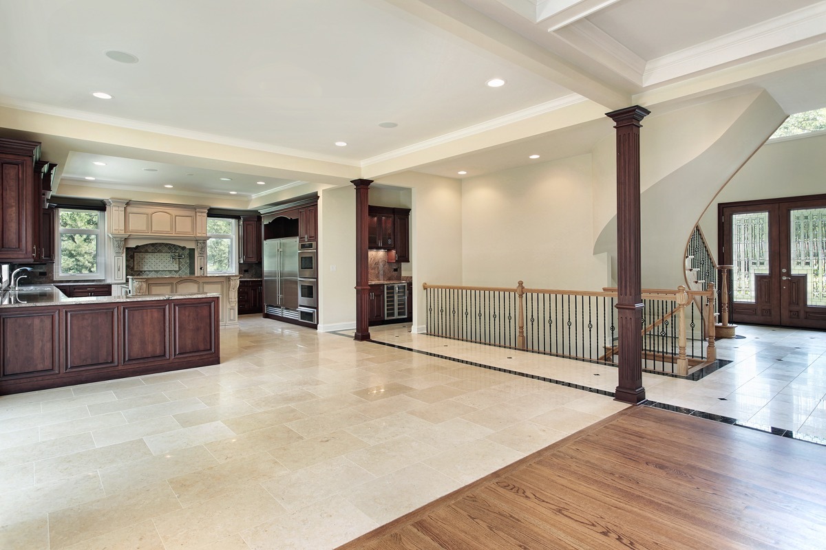 living room with hardwood floors and kitchen with tile flooring