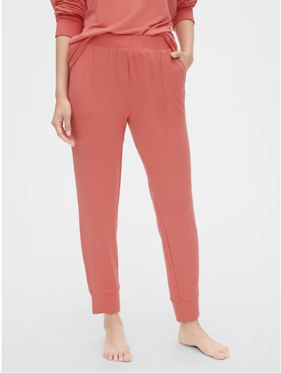 white woman wearing pink pants and top