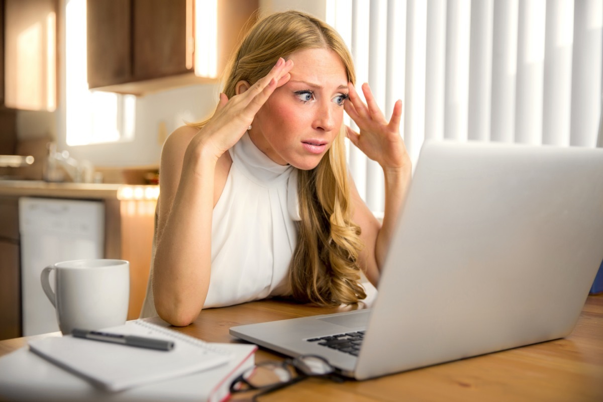 Young woman looking exasperated at computer