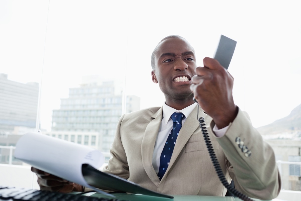 Angry black businessman on phone, things not to say to customer service