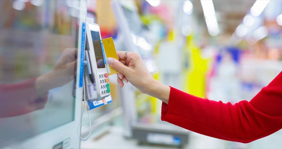 woman using self checkout machine