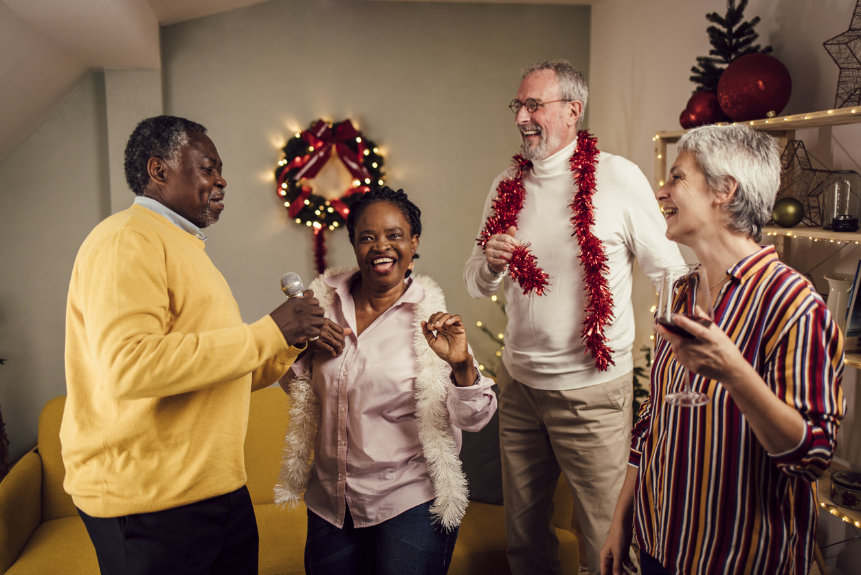 seniors singing and enjoying christmas music together at home