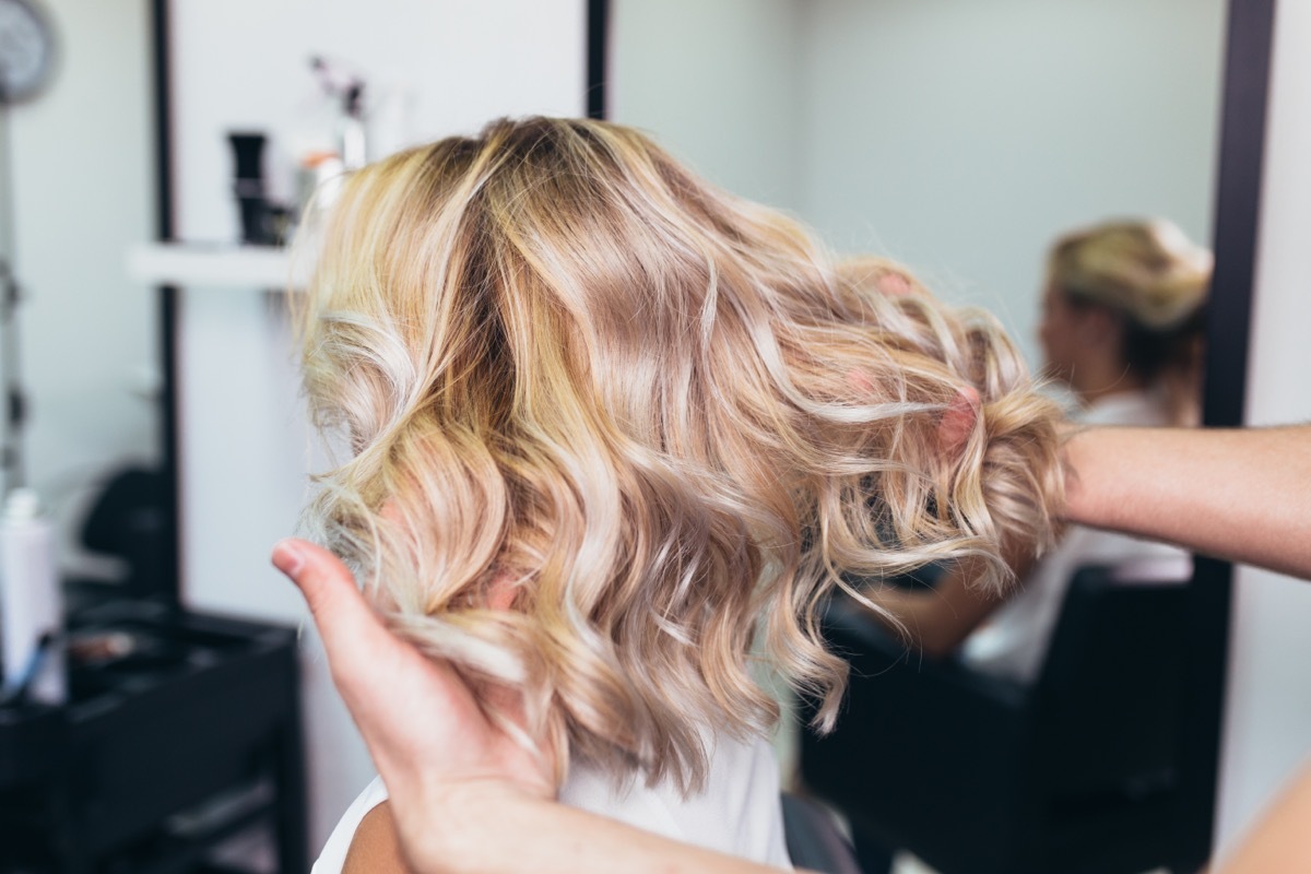 Woman at hair salon with blonde hair. 