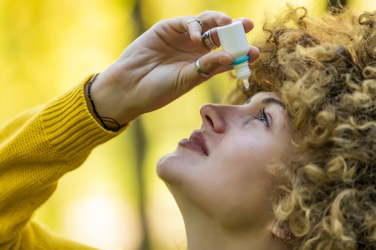 Woman putting eye drops in dry eyes