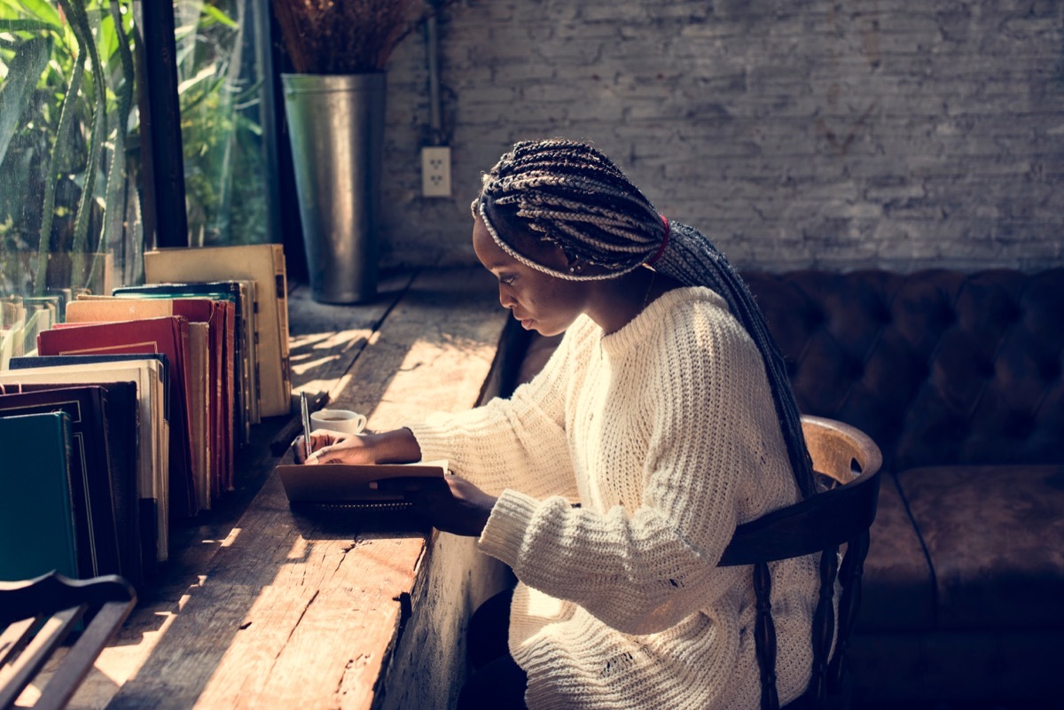 Woman writing goals in her journal