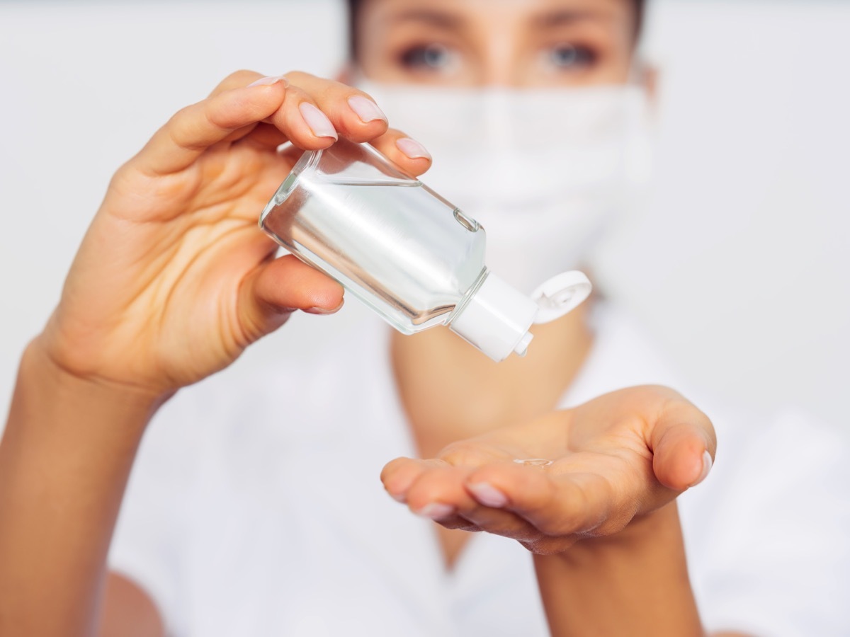 Woman with a small bottle of hand sanitizer