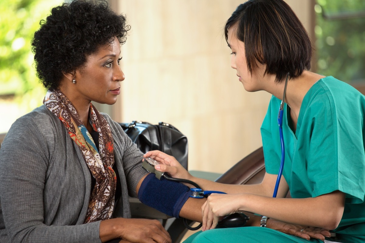 Woman at the Doctor Getting Her Blood Pressure Checked Lower Blood Pressure Naturally